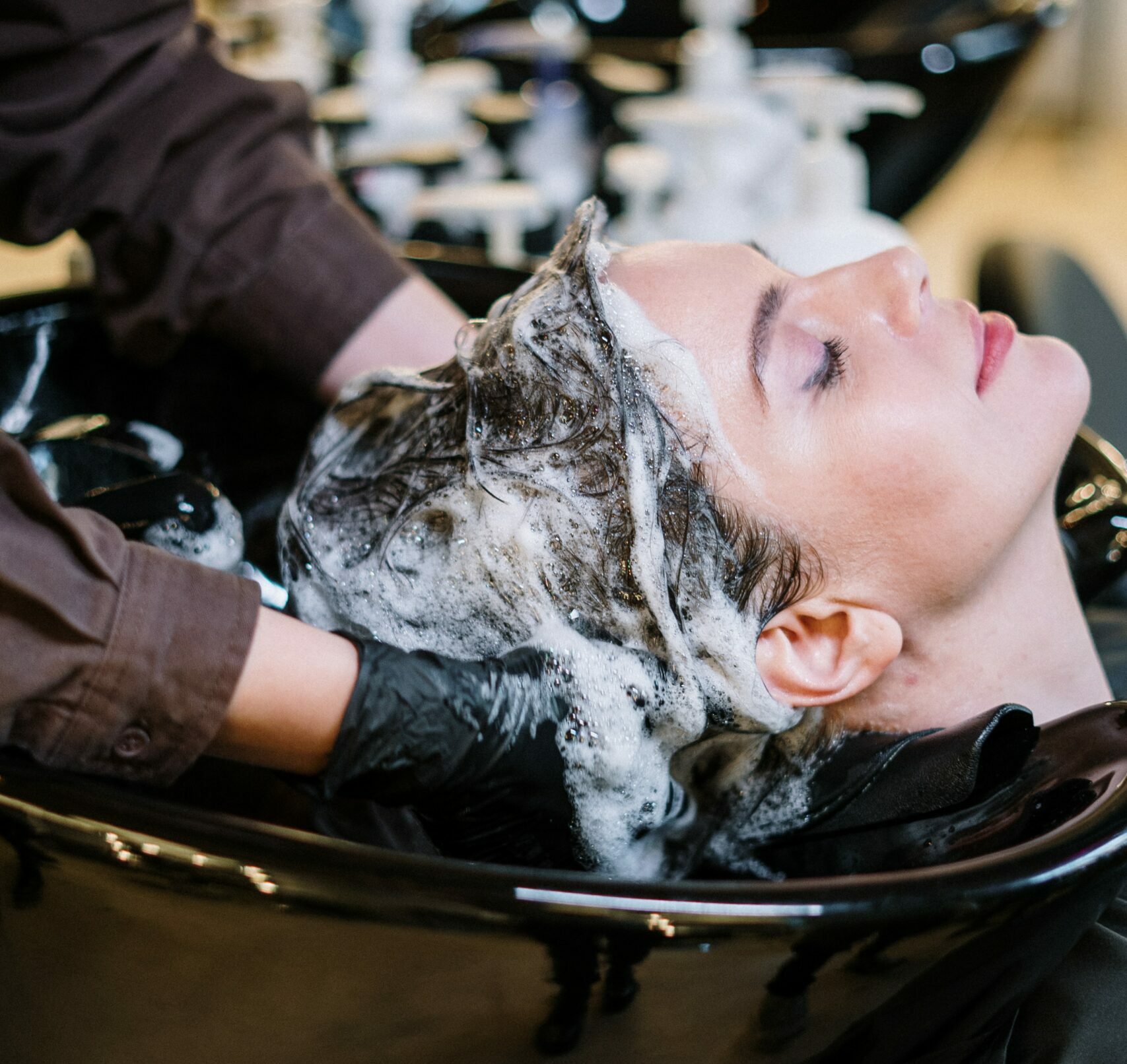 Hair Dresser washing girls hair